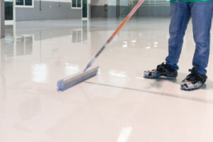 Epoxy coatings are robust, resin-based systems applied to concrete surfaces